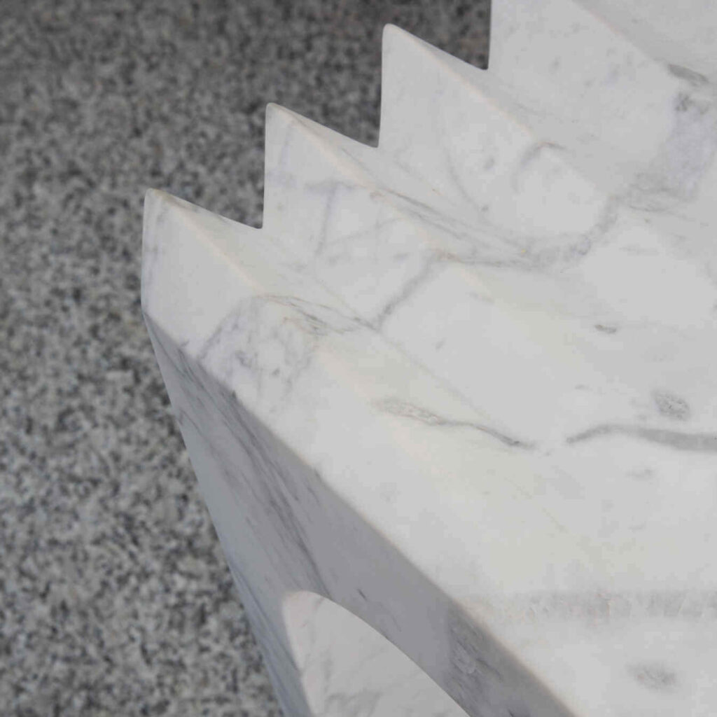 Focus on the natural stone texture, highlighting the unique characteristics of each Carrara marble piece.