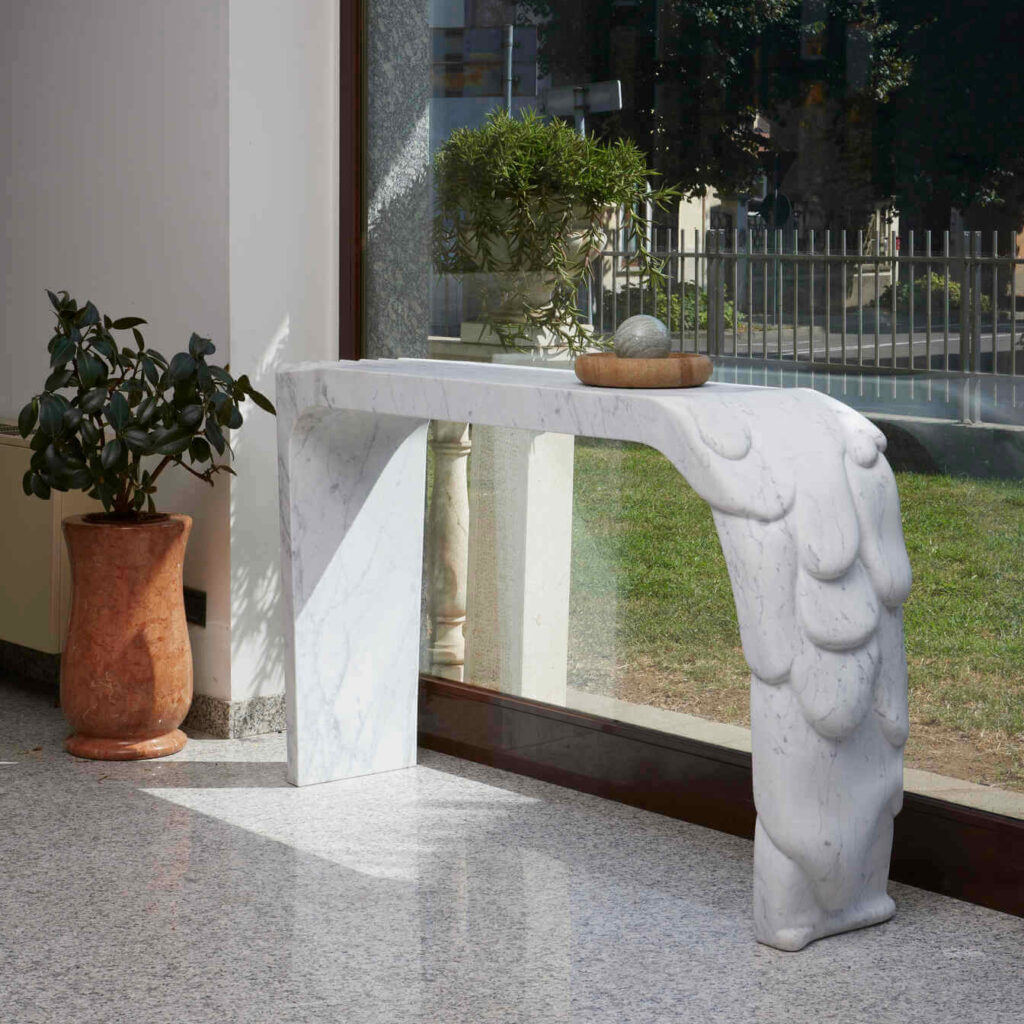 View of the console against natural lighting, accentuating the marble's reflective qualities and elegance.